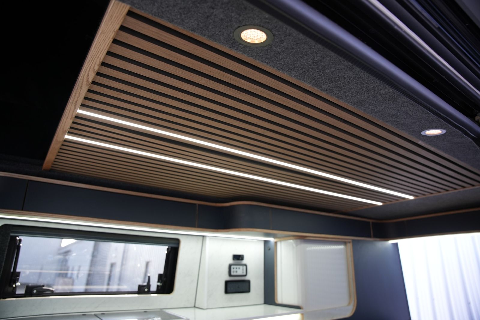 Slatted feature ceiling: Wood slats, LED strips and spotlights.
