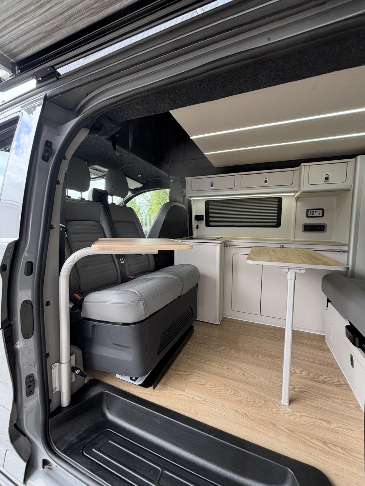 Rock & roll bed & swivel seat: Grey upholstery, oak-effect floor.