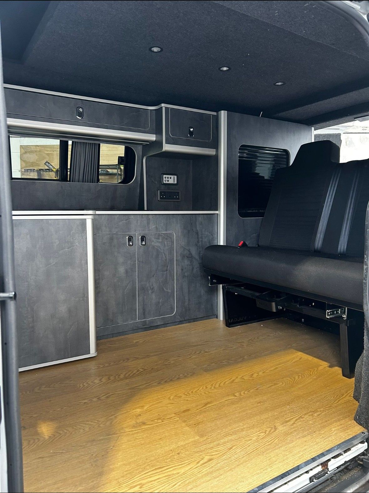 Carpet-lined interior: Grey units and rock & roll bench.