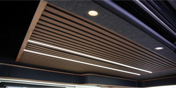 Carpet-lined ceiling with wooden slats and LED strip lighting